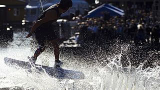 A wakeboarder takes off against the light during a wakeboard event organised by a drinks company in Hamburg, Germany