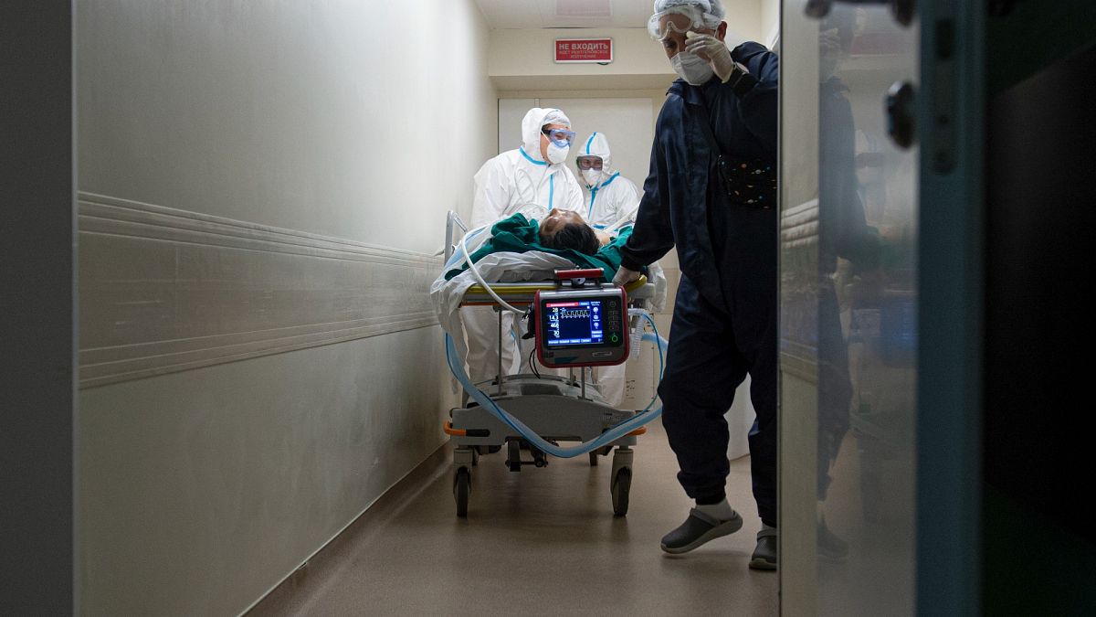 Medics transport a patient with COVID-19 at the City hospital No. 52 for coronavirus patients in Moscow, Russia, July 13, 2021.