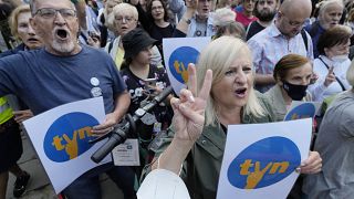 People demonstrate in defense of media freedom in Warsaw, Poland, on Tuesday, Aug. 10, 2021. 