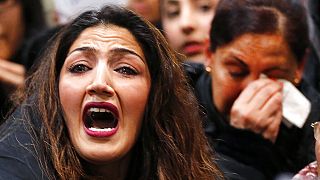 A demonstrator shouts during a protest against the deportation of 50 Afghan asylum seekers at the airport in Frankfurt, Germany, Wednesday, Dec. 14, 2016