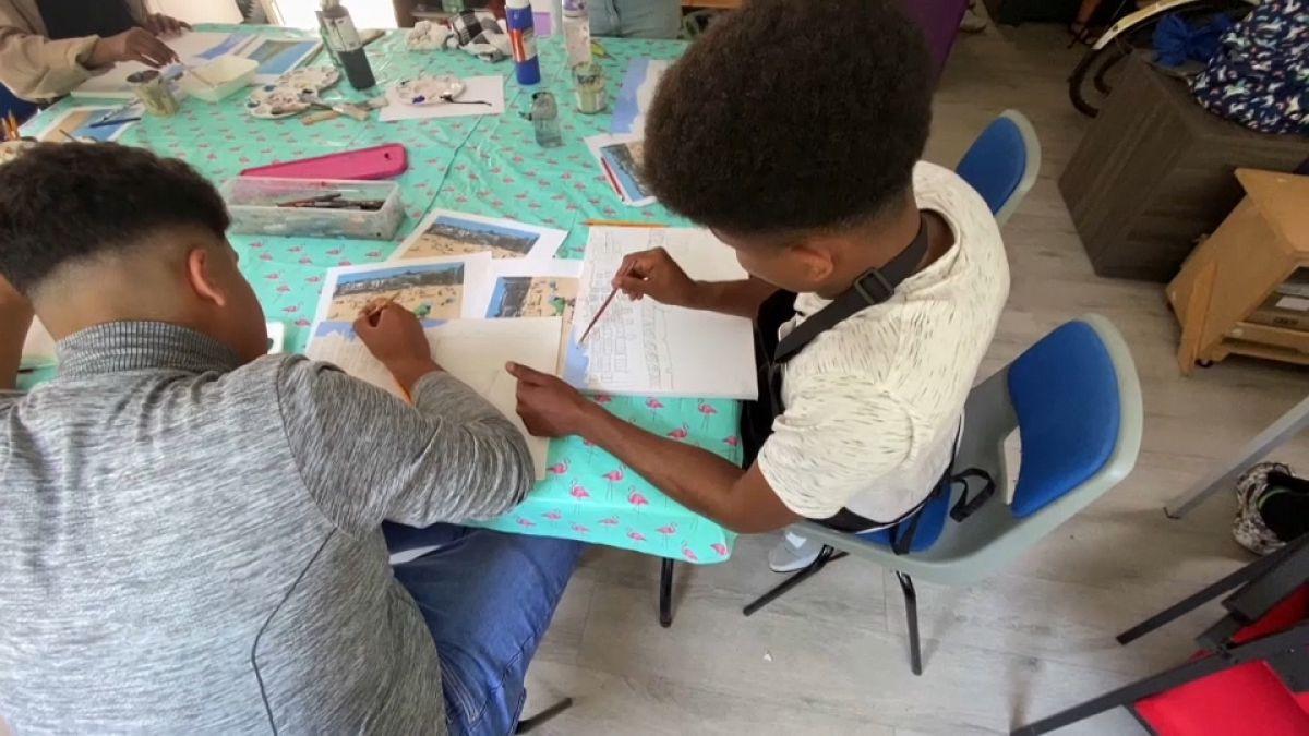 Children refugees painting and drawing at an art class in Folkestone, England. 