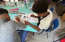 Children refugees painting and drawing at an art class in Folkestone, England.