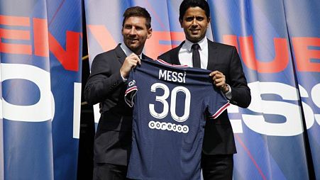 Lionel Messi poses with Paris St Germain president Nasser Al-Khelaifi at his unveiling.