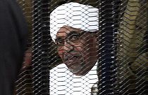 In this file photo taken in August 2019, Sudan's deposed military ruler Omar al-Bashir looks on from a defendant's cage during the opening of his corruption trial in Khartoum.