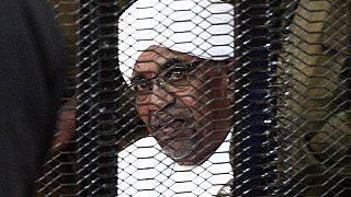 In this file photo taken in August 2019, Sudan's deposed military ruler Omar al-Bashir looks on from a defendant's cage during the opening of his corruption trial in Khartoum.