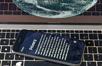 his Oct. 2, 2020 file photo shows an iPhone screen with Apple's privacy policy reflected on a laptop screen in Los Angeles. 