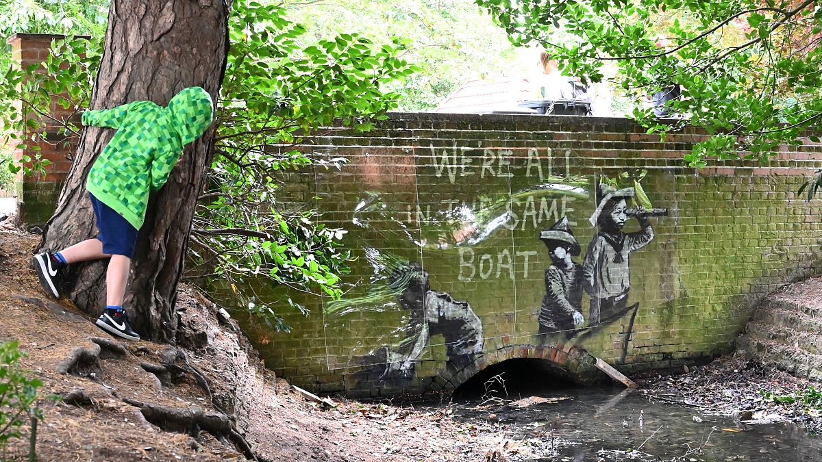 A graffiti artwork bearing the hallmarks of street artist Banksy on the wall of a bridge in Everitt Park in Lowestoft on the East coast of England