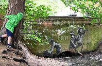 A graffiti artwork bearing the hallmarks of street artist Banksy on the wall of a bridge in Everitt Park in Lowestoft on the East coast of England