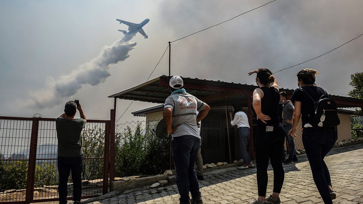 File photo of a plane pouring water over a fire-devastating village, near Manavgat, Antalya, Turkey