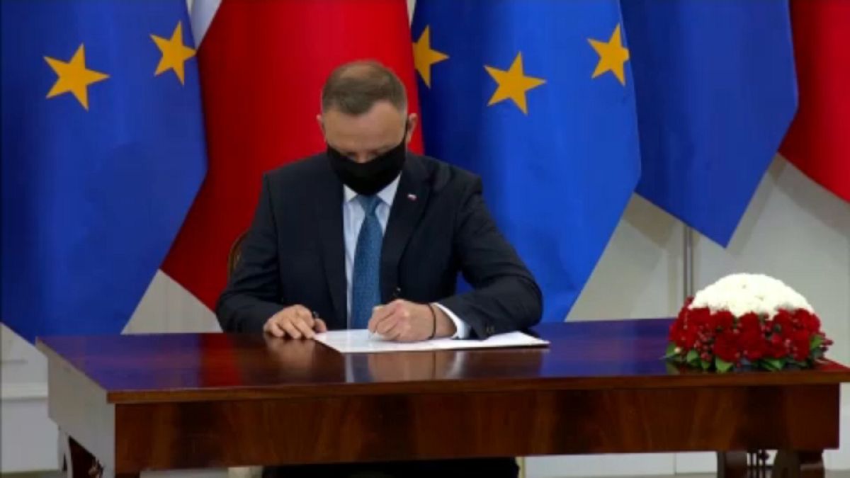 Polish President Andrzej Duda signing the document