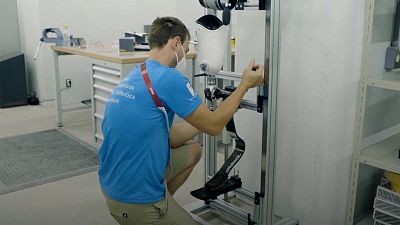 A specialist repairs a prosthetic limb in the Paralympic village in Tokyo.