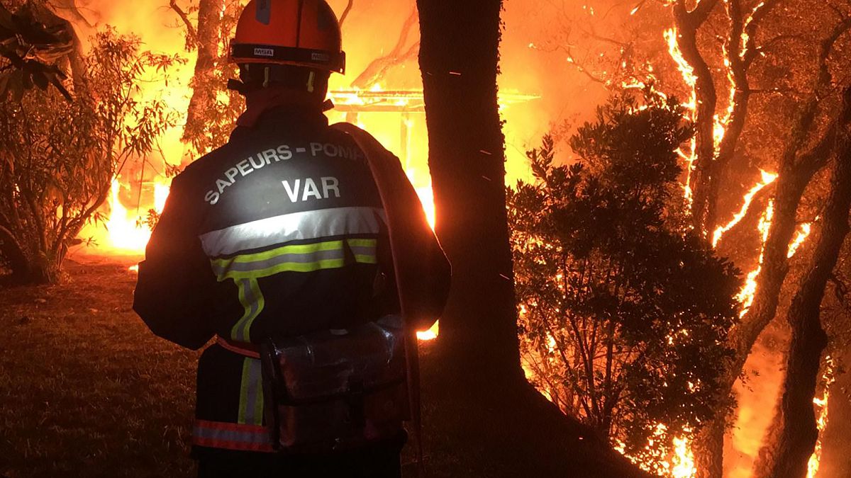 In this photo provided by the fire brigade of the Var region, a fireman battles with a fire near Toulon, Aug. 17, 2021. 