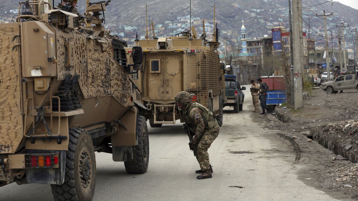 British soldiers with NATO-led Resolute Support Mission forces arrive at the site of an attack in Kabul, Afghanistan, Wednesday, March 25, 2020.