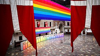 A rainbow flag is suspended at Copenhagen City Hall on Wednesday Aug. 11, 2021, marking the opening of Copenhagen 2021, World Pride and Eurogames