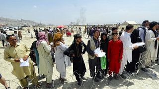 Hundreds of people gather outside the international airport in Kabul, Afghanistan, Aug. 17, 2021.