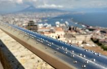 The braille engraved railing at Castel Sant’Elmo with the view of Mount Vesuvius in the background.