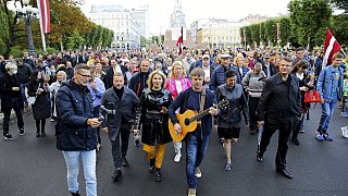 Protesters march during a protest against mandatory vaccinations, in Riga, Latvia