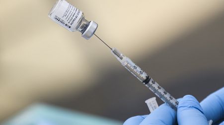 In this file photo a syringe is filled with a first dose of the Pfizer Covid-19 vaccine at a mobile vaccination clinic at the Weingart East Los Angeles YMCA in Los Angeles
