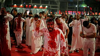 Shiite faithful self-flagellate to show their grief during a Muharram procession marking Ashoura, outside the holy shrine of Imam Hussein in Karbala.