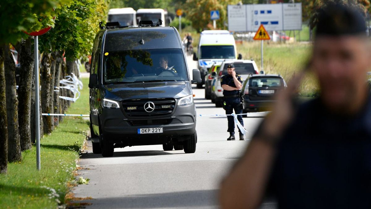 Police stand guard at the scene of an attack at a high school in Eslöv.