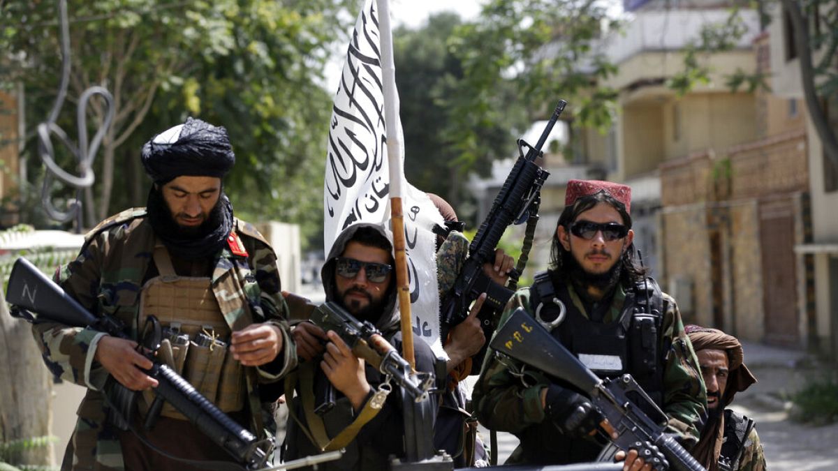 In this Aug. 19, 2021 file photo, Taliban fighters display their flag on patrol in Kabul, Afghanistan.