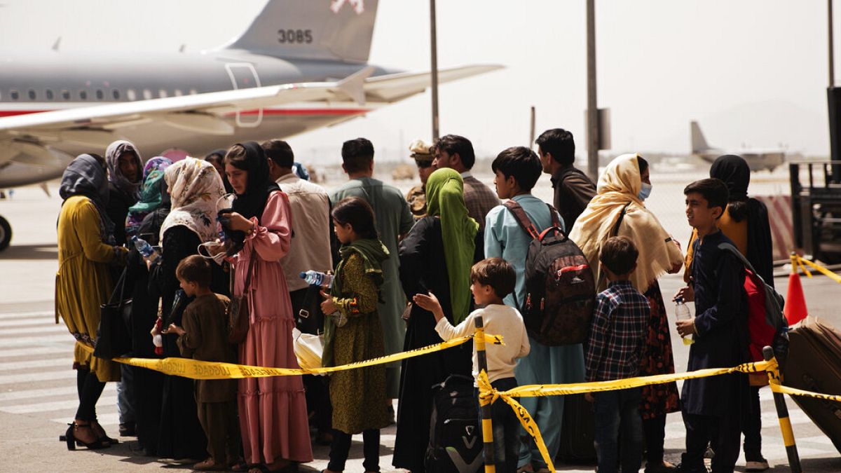 Civilians prepare to board an evacuation plane out of Kabul Airport.