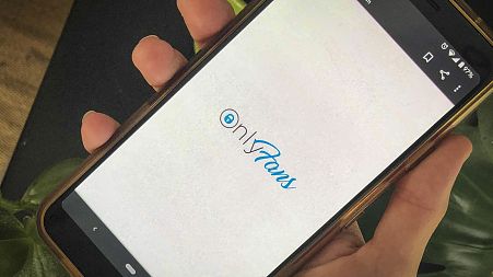 This photo shows a phone app for OnlyFans, a site where fans pay creators for their photos and videos, Aug. 19, 2021.