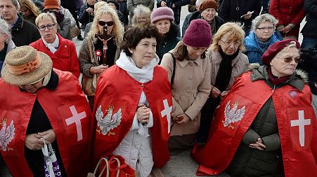 Polish Catholics pray at an anti-gay event in Warsaw, Poland.