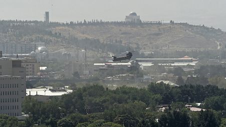 FILE-A US military helicopter is pictured flying above the US embassy in Kabul on August 15, 2021.