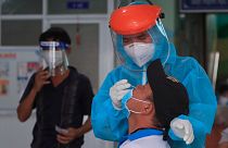 A medical worker takes swab sample from a man in Vung Tau city, Vietnam Saturday, Aug. 21, 2021.