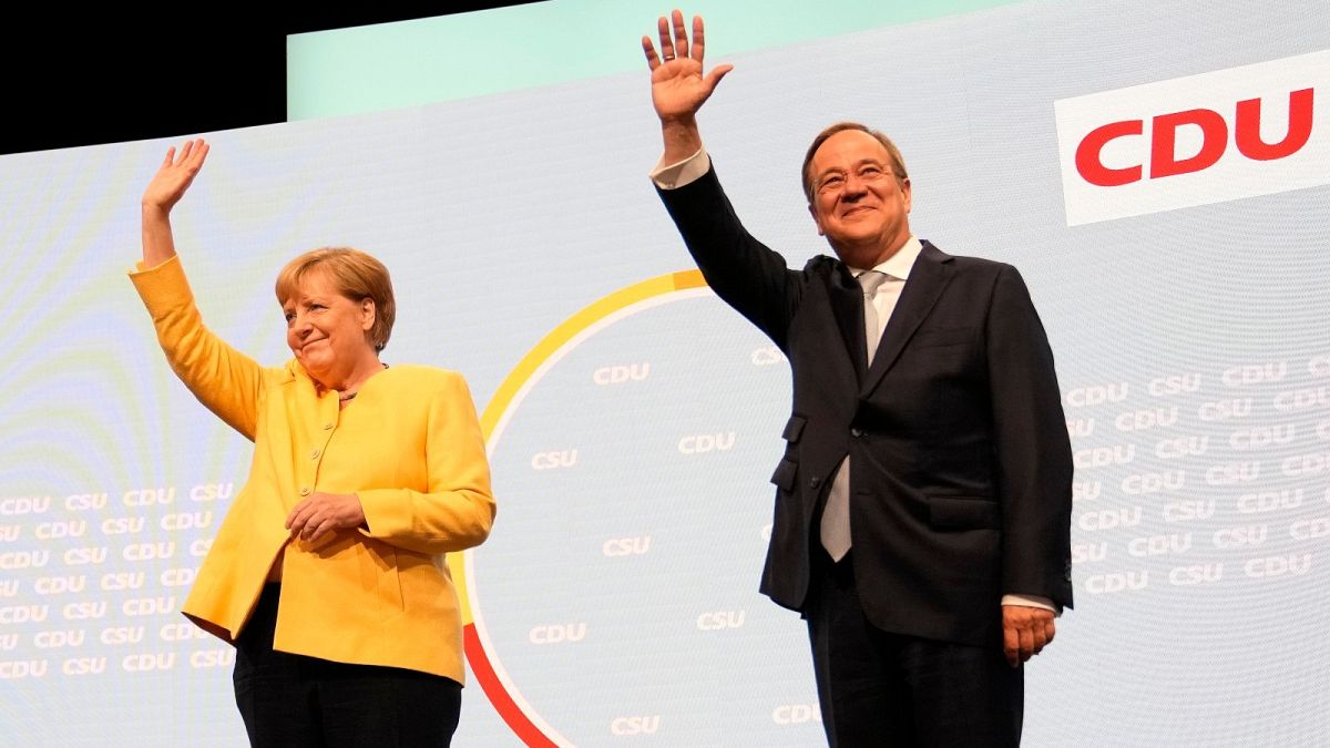 Armin Laschet, the CDU's candidate for chancellor in Germany's September election, right, and outgoing Chancellor Angela Merkel arrive for an event in Berlin.