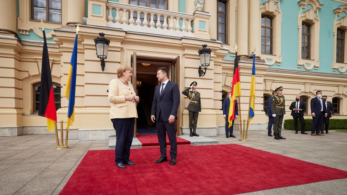 Ukrainian President Volodymyr Zelenskyy, right, greets German Chancellor Angela Merkel during their meeting in Kyiv, Ukraine, Sunday, Aug. 22, 2021.