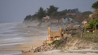 A house destroyed by the sea stand on the beach in Atafona