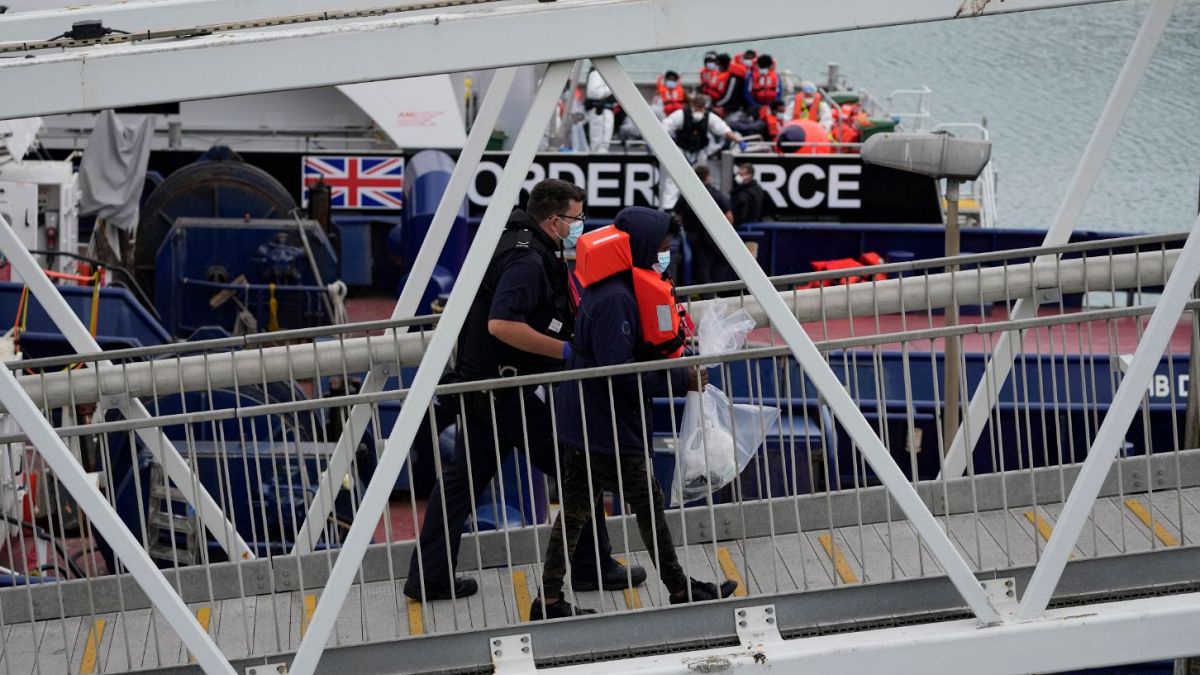 A suspected migrant disembarks after being picked up in the Channel by a British border force vessel in Dover.
