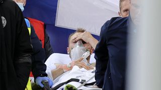 Paramedics use a stretcher to take Denmark's Christian Eriksen off the pitch after he collapsed during the Euro 2020 soccer championship group B match against Finland