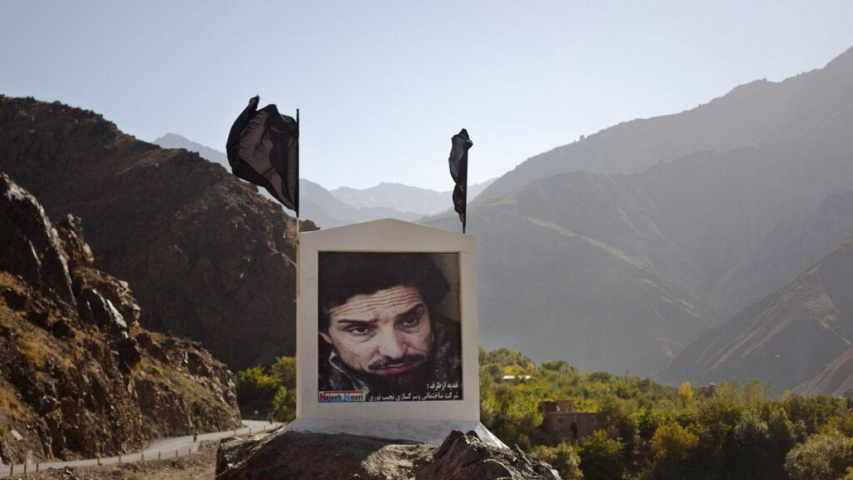 In this Sept 28, 2011 file photo, a large poster of late charismatic guerrilla fighter Ahmad Shah Massoud is displayed next to a road leading into the Panjshir Valley.