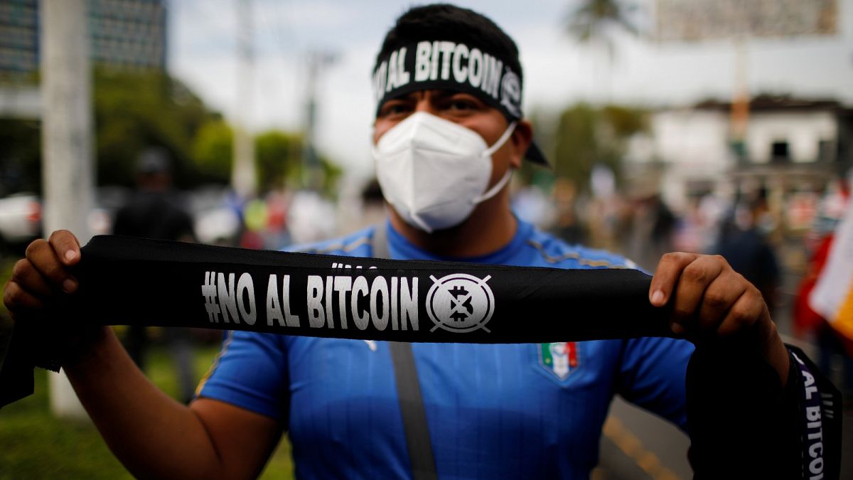 A man sells badanas that reads "No to Bitcoin" in a war veterans protest to ask for better pensions and against the use of Bitcoin as legal tender in San Salvador, El Salvador