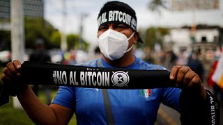 A man sells badanas that reads "No to Bitcoin" in a war veterans protest to ask for better pensions and against the use of Bitcoin as legal tender in San Salvador, El Salvador