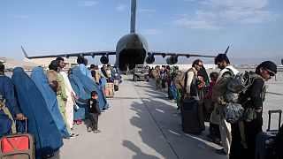 This handout photo from the US Air Force shows evacuees boarding a US transport plane at Hamid Karzai International Airport (HKIA), Afghanistan, August 24, 2021.