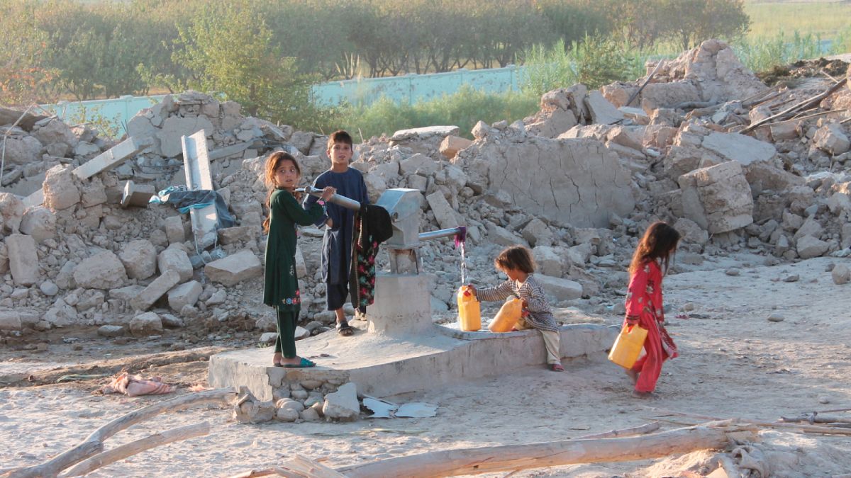 Afghan children fill water containers from a public water tap, Helmand, Aug. 21, 2021