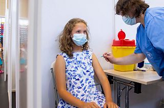 13 year-old Gloria Raudjarv receives a COVID-19 vaccine in Estonia.
