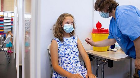 13 year-old Gloria Raudjarv receives a COVID-19 vaccine in Estonia.