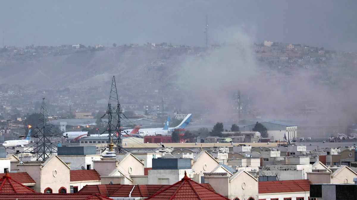 Smoke rises into the air after the explosion at Kabul airport on Thursday