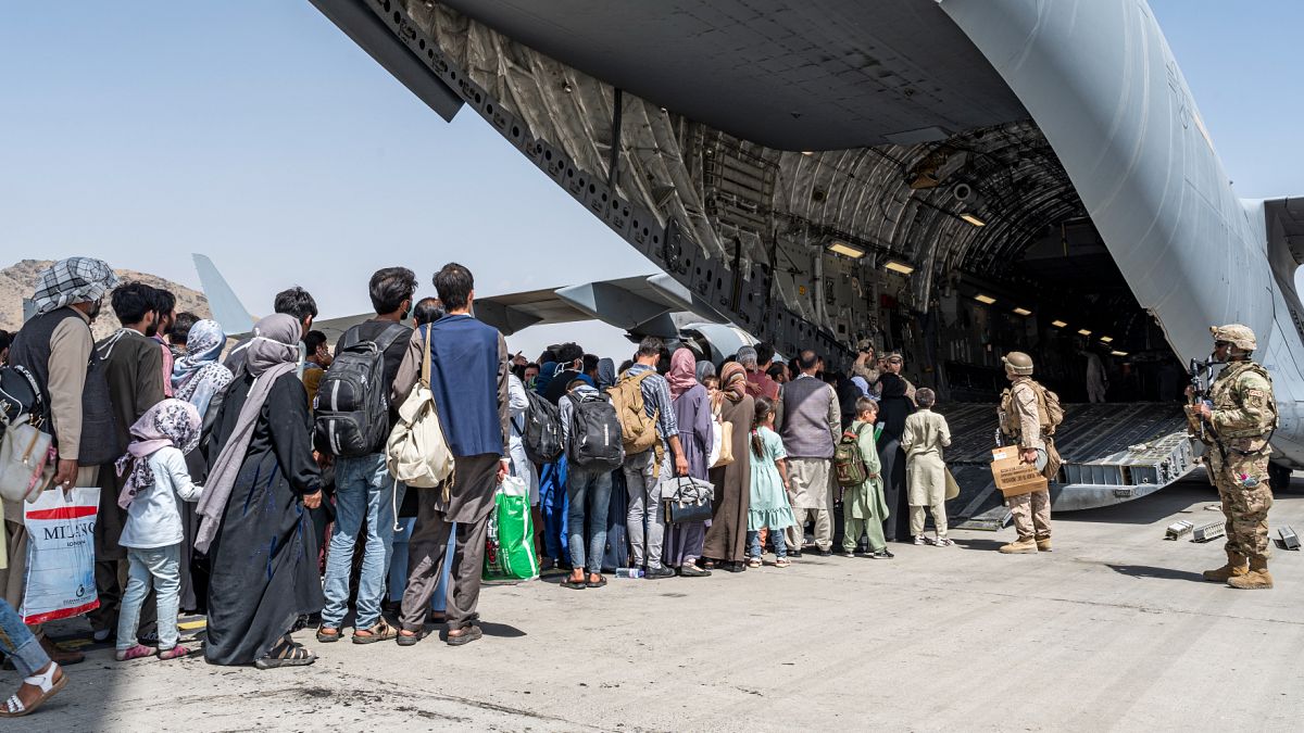 Evacuees aboard a US military aircraft at the airport in Kabul, Aug. 21, 2021