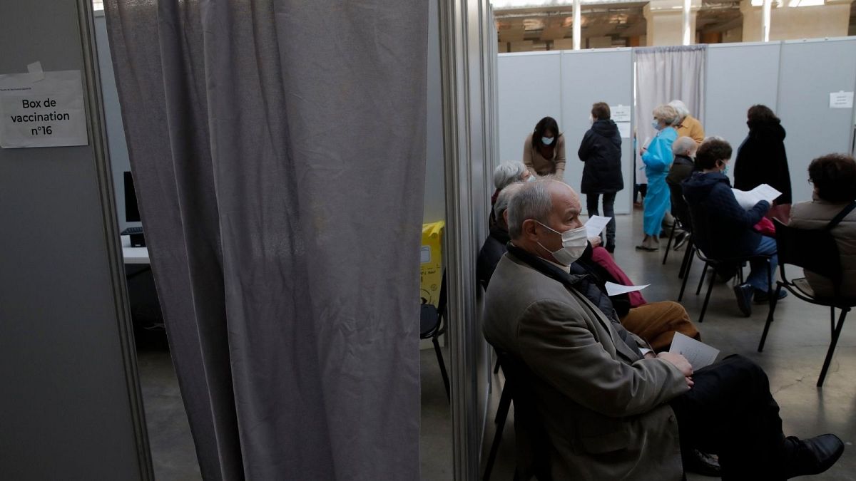 People wait to receive Pfizer's COVID-19 vaccine at a vaccination site in Paris, Saturday, March 6, 2021. 