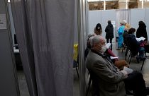 People wait to receive Pfizer's COVID-19 vaccine at a vaccination site in Paris, Saturday, March 6, 2021.