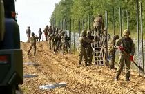 Soldiers building fence along border