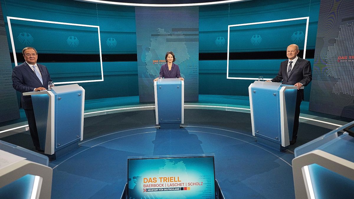 Candidates for chancellor from left, Armin Laschet, Annalena Baerbock and Olaf Scholz stand before the broadcast in the TV studio in Berlin, Sunday, Aug. 29, 2021. 