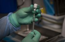 A health worker prepares a syringe with the Pfizer COVID-19 vaccine on Aug. 26, 2021, in Santa Ana, Calif.