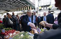 Britain's Prime Minister Boris Johnson shops at a fruit and vegetable stall during a visit to Doncaster Market, in Doncaster, Northern England, Friday Sept. 13, 2019. Britain's Prime Minister Boris Johnson shops at a fruit and vegetable stall during a visit to Doncaster Market, in Doncaster, Northern England, Friday Sept. 13, 2019.